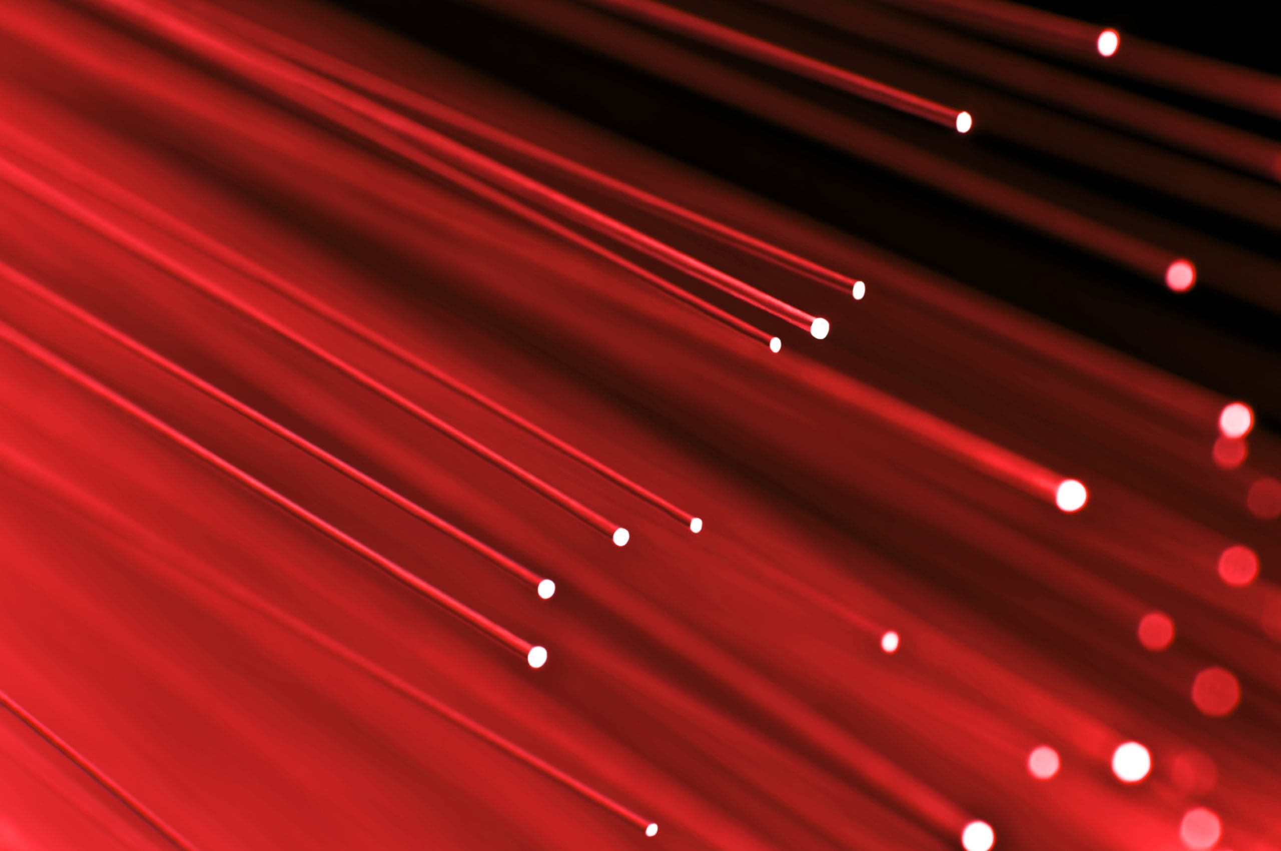 The image features red lights against a black background, creating an abstract and colorful visual effect.